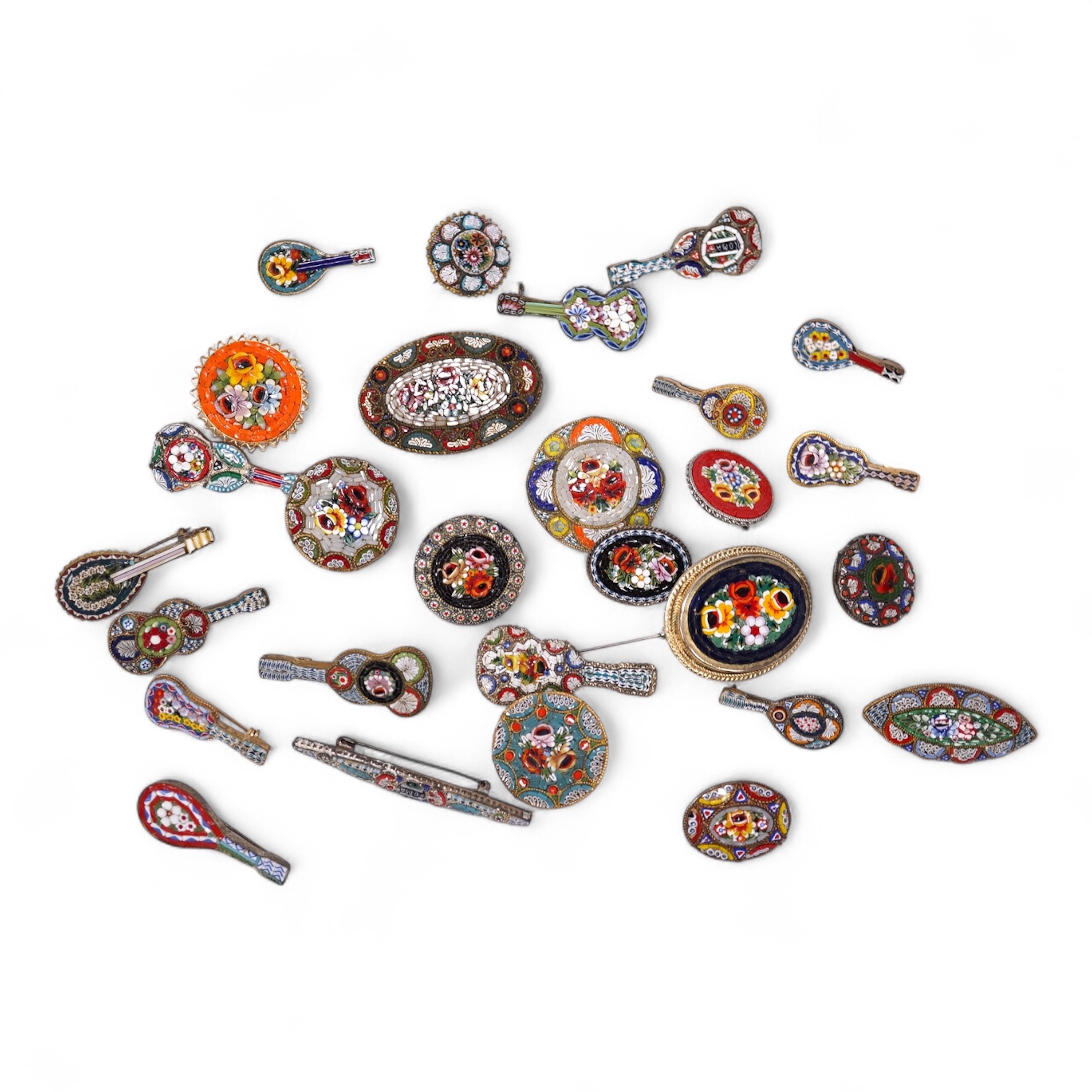 A collection of twenty-eight brooches, including fourteen mixed guitar and banjo shaped brooches, six large oval brooches, seven smaller brooches and one small oval., Condition - good